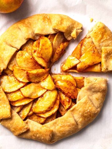 Overhead view of an apple galette with a slice cut out