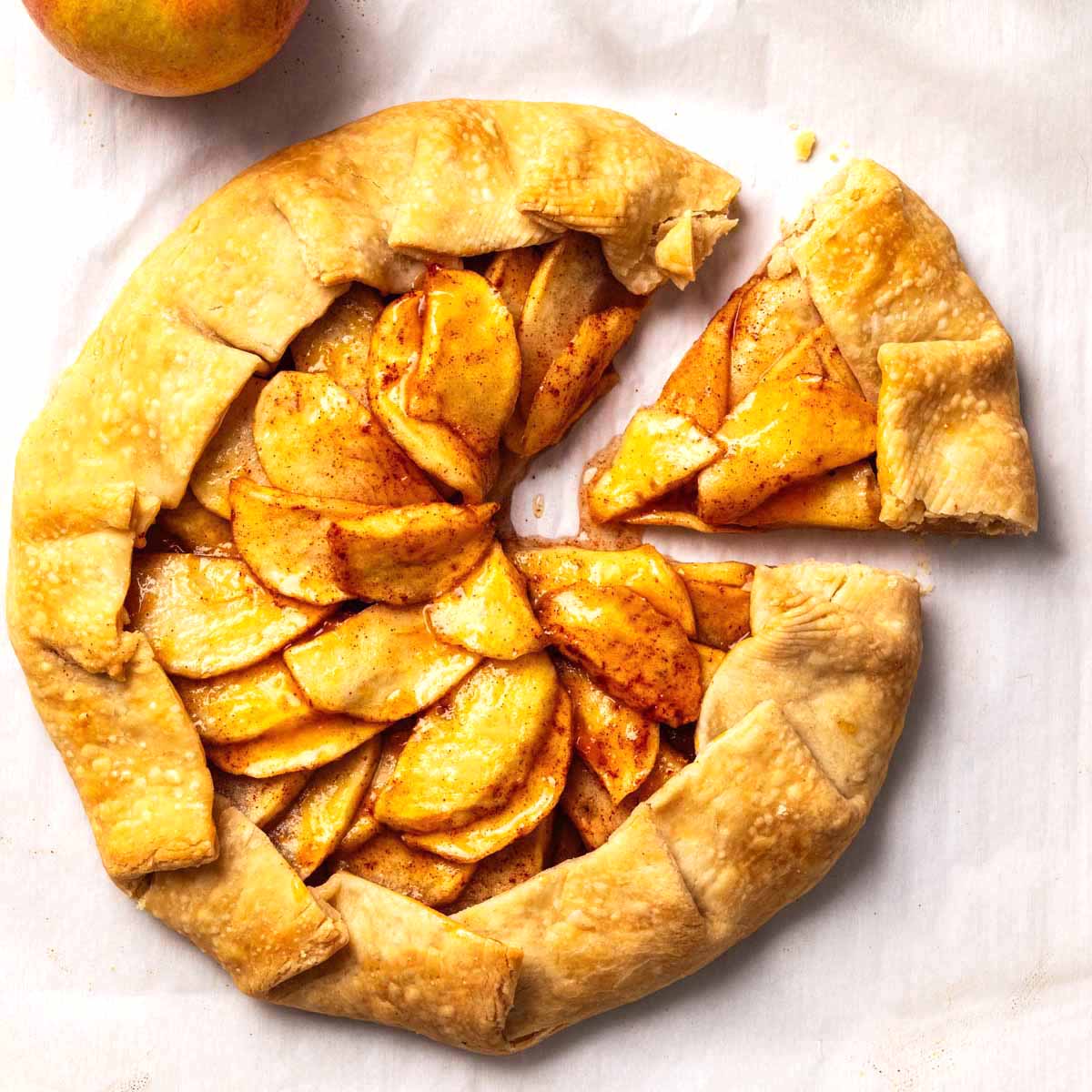 Overhead view of an apple galette with a slice cut out