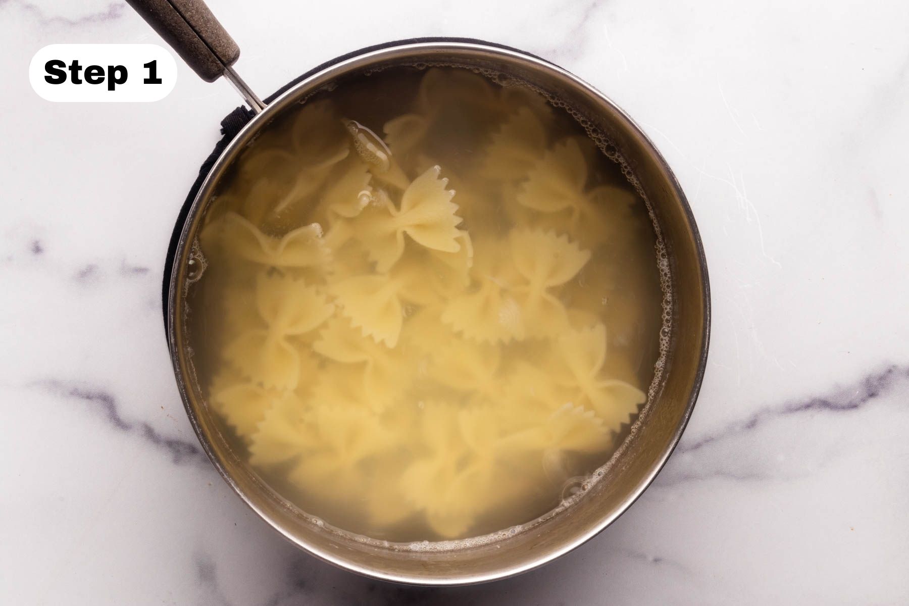 Bowtie pasta cooking in a pan