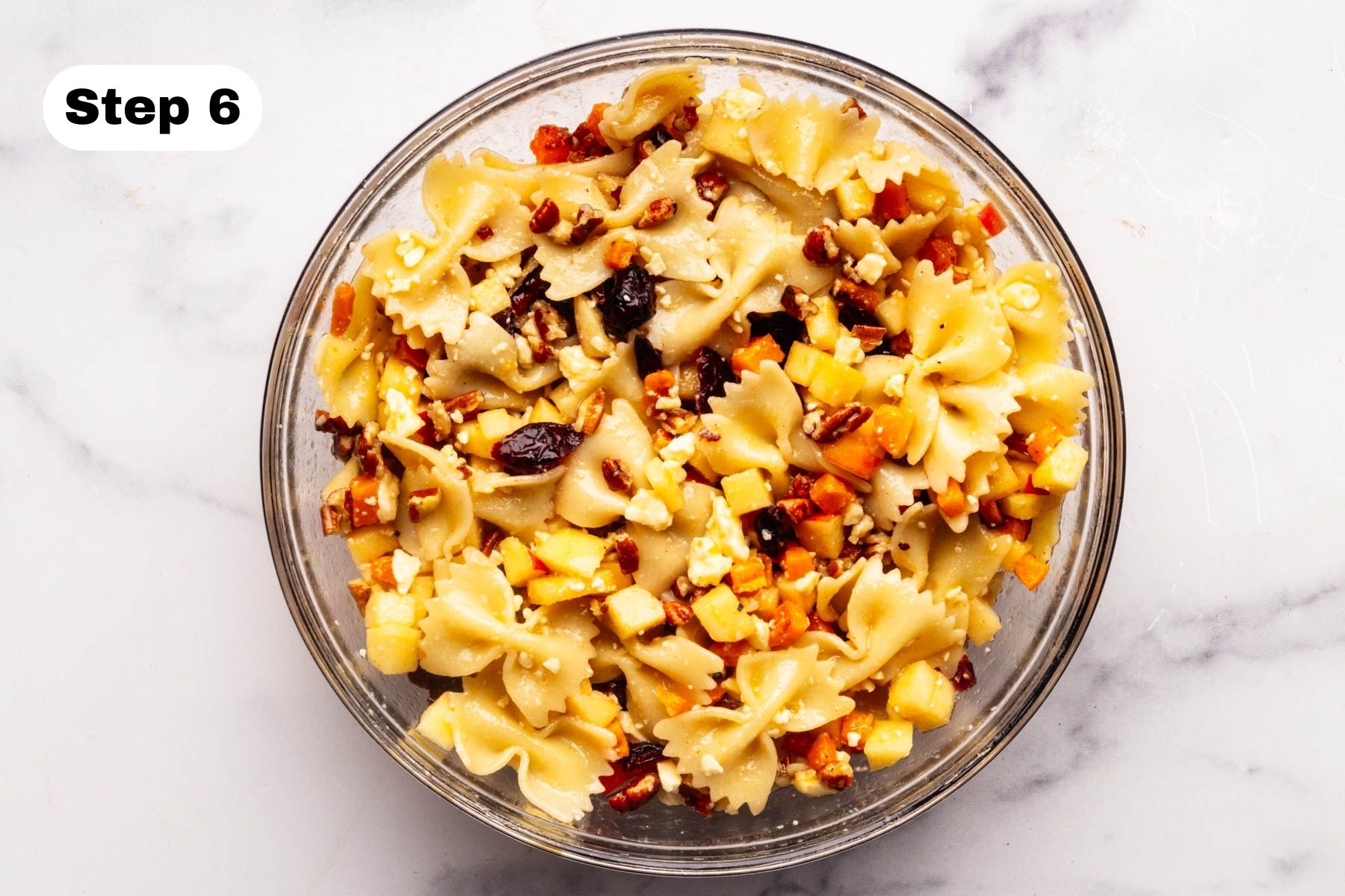 Pasta salad combined in a glass bowl