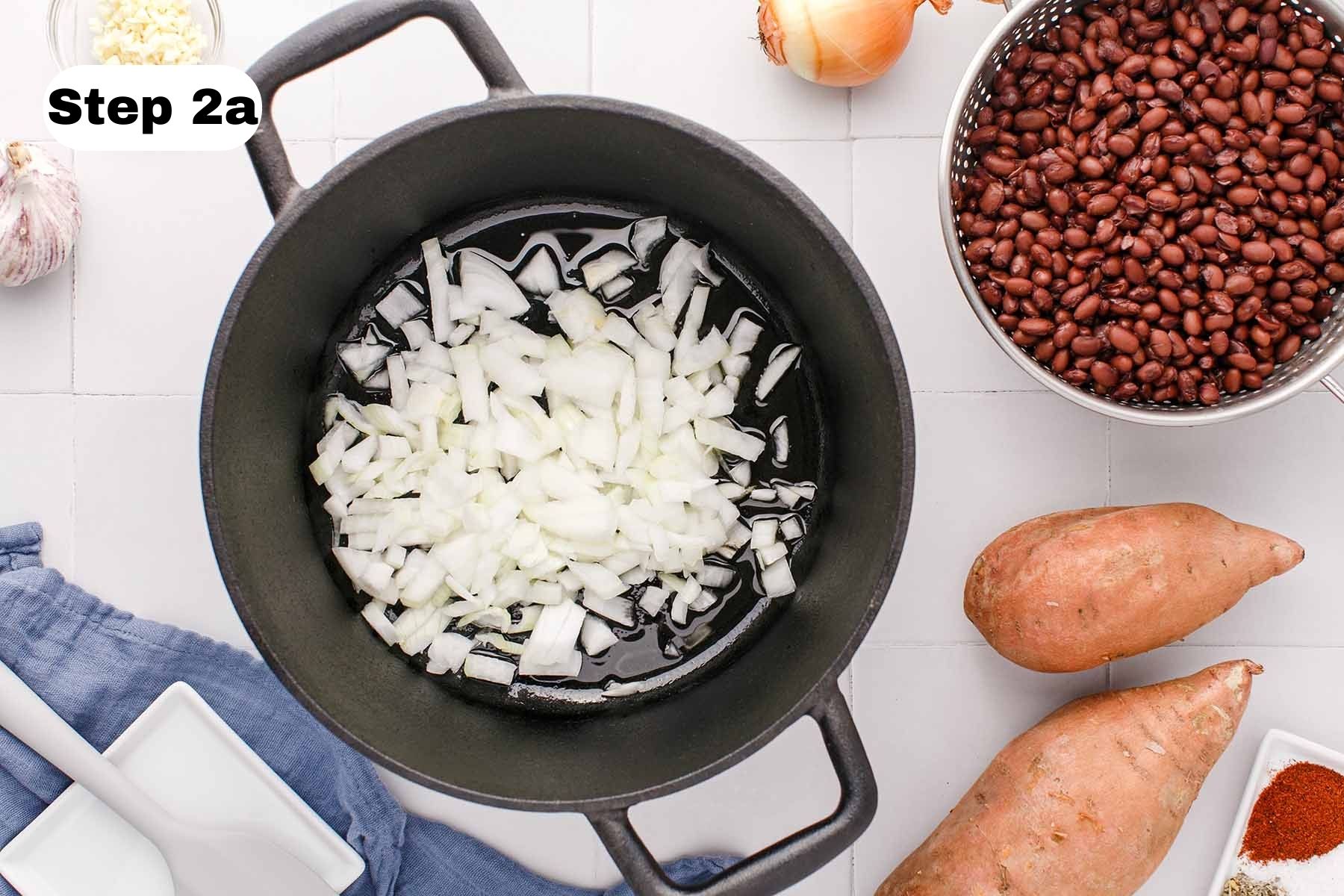 Uncooked chopped onion in a soup pot