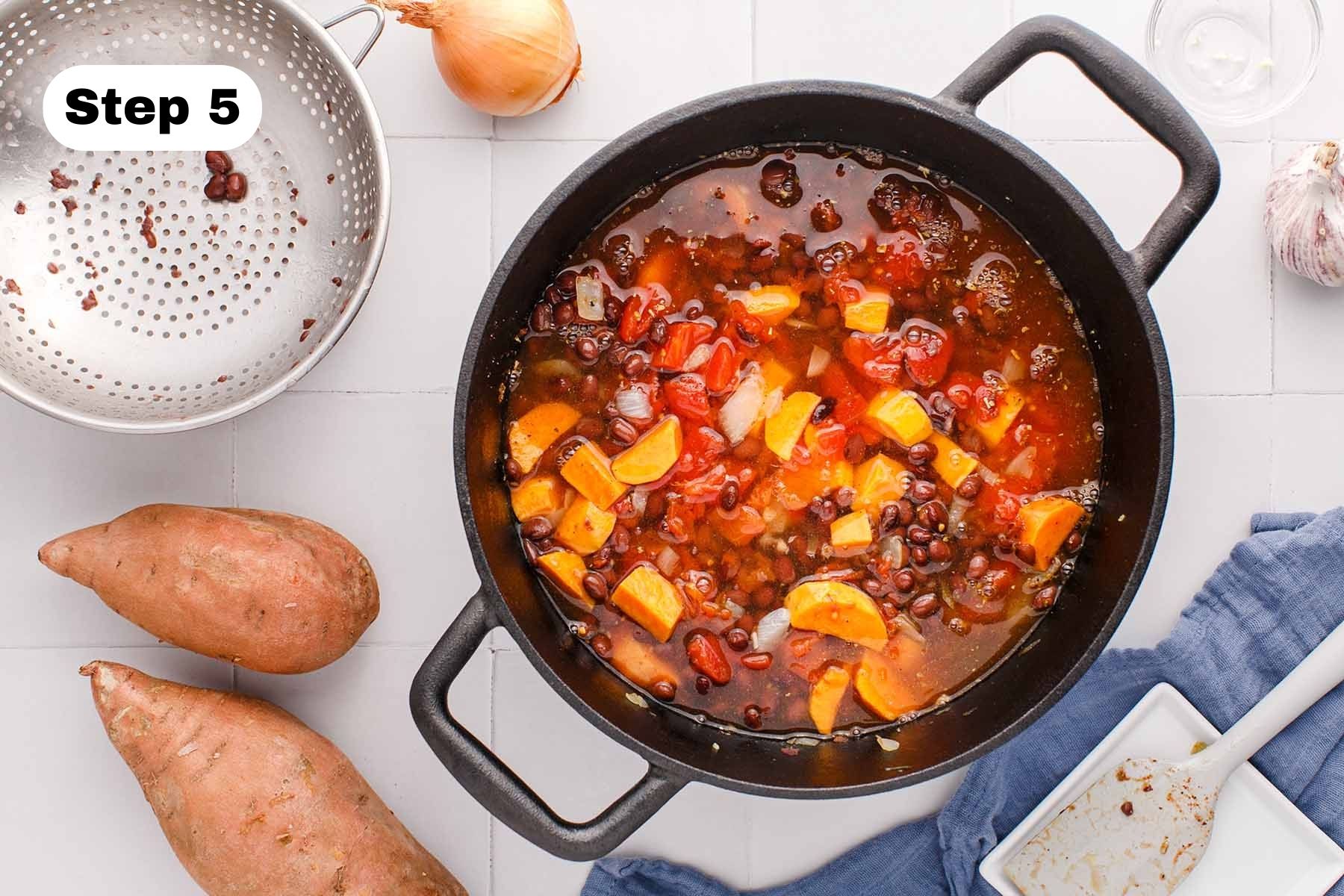 All ingredients in a soup pot with vegetable broth