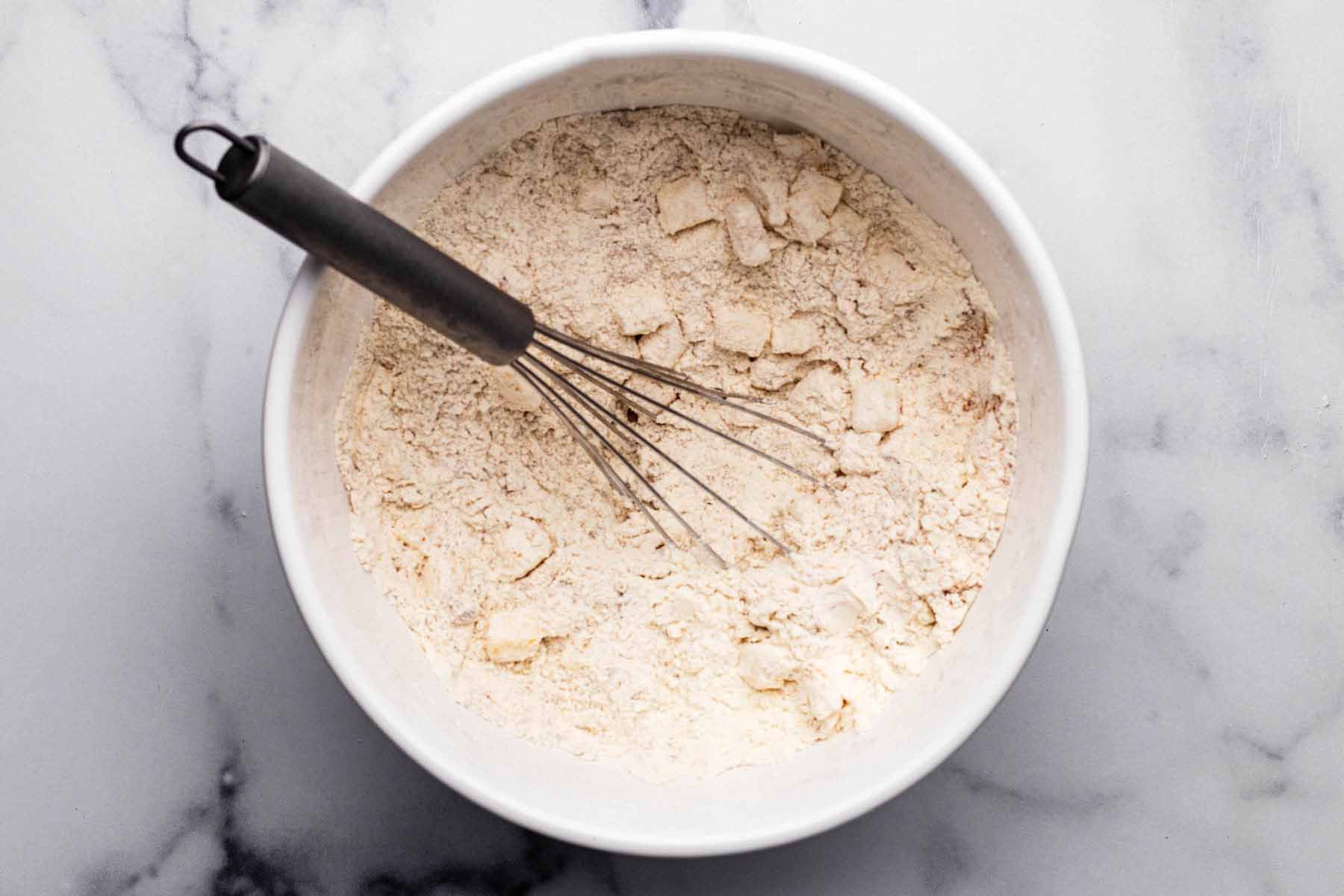 All dry ingredients whisked together in a white mixing bowl