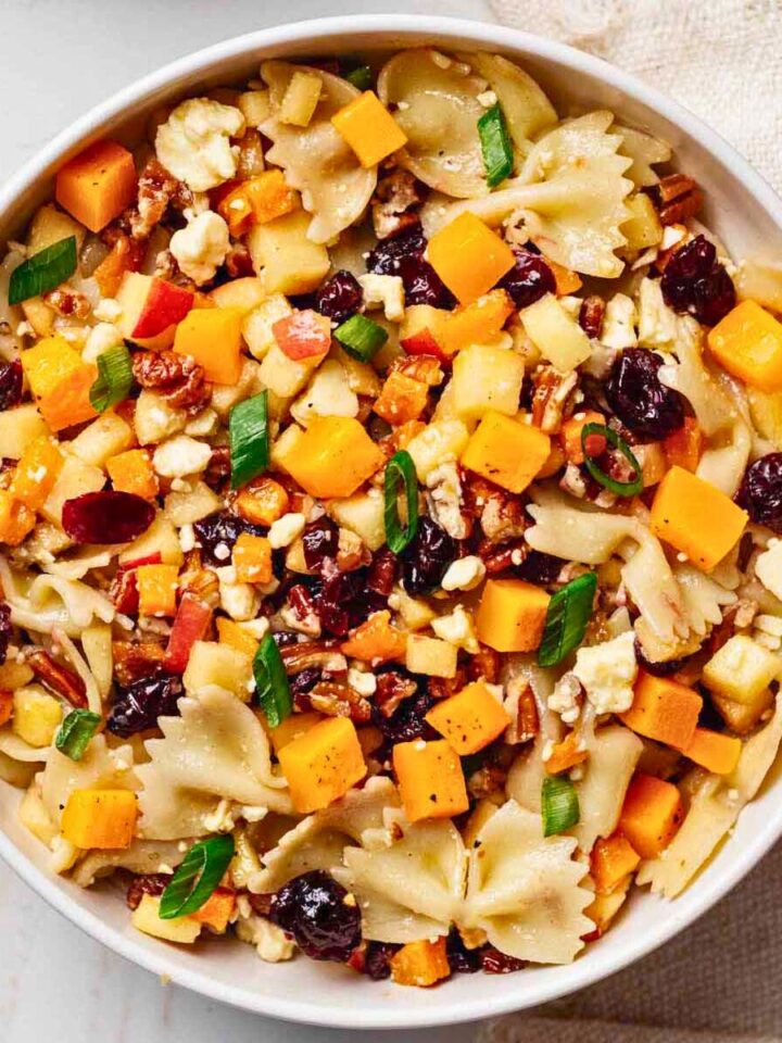 Overhead view of autumn pasta salad in a white serving bowl