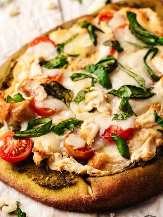 Close up of a whole chicken pesto flatbread on crumpled paper
