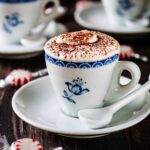 Close up of a serving of espresso chocolate mousse being served in a small blue floral espresso cup with a small white espresso spoon.