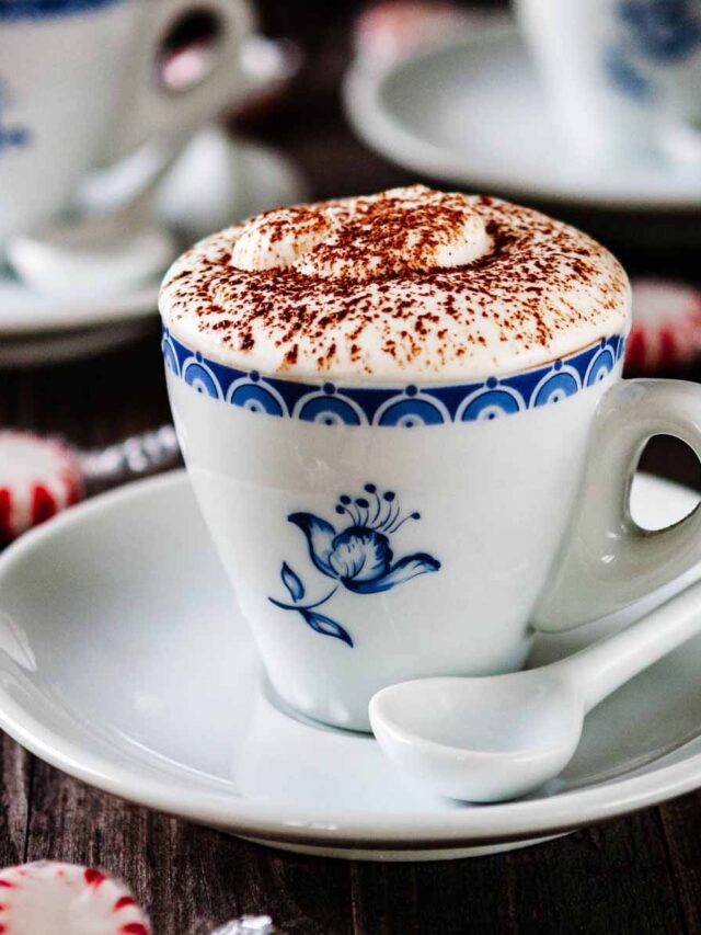 Close up of a serving of espresso chocolate mousse being served in a small blue floral espresso cup with a small white espresso spoon.