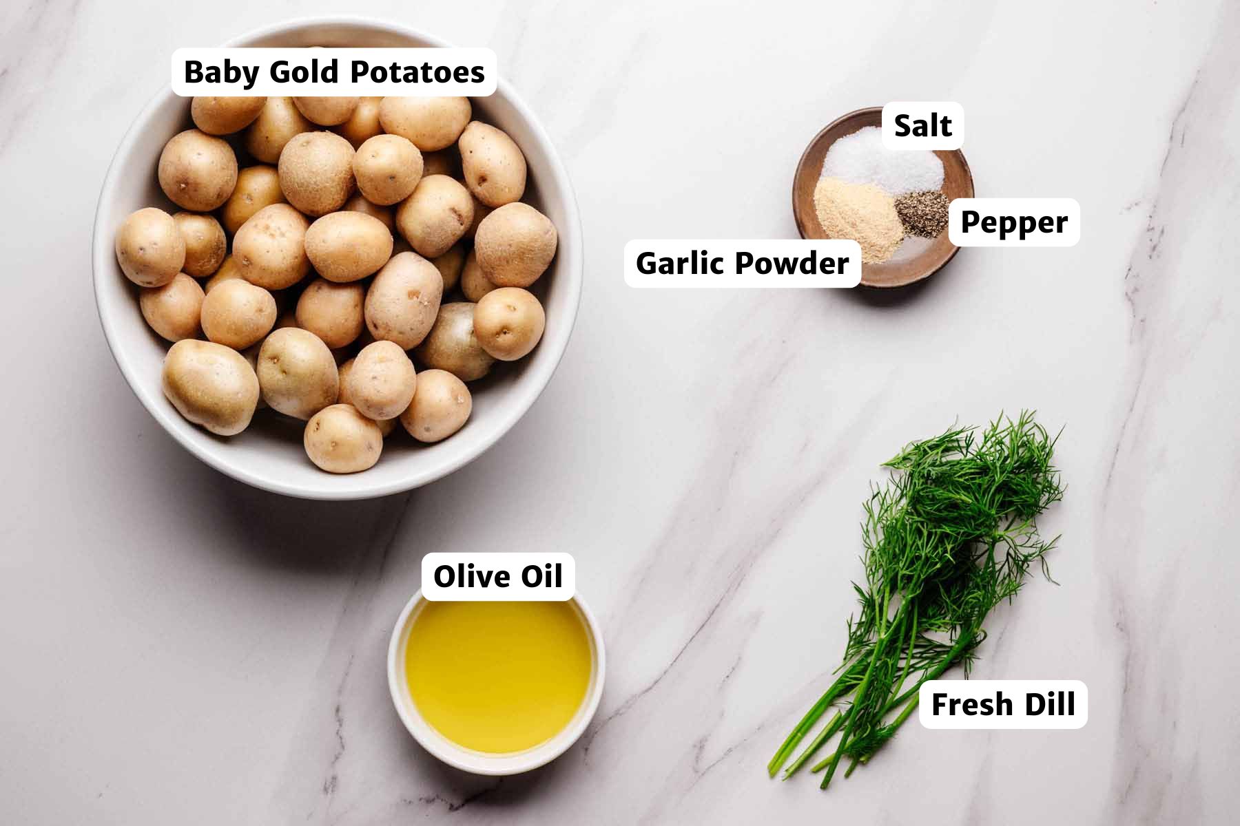 Ingredients for dill roasted potatoes: baby gold potatoes, olive oil, fresh dill, garlic powder, salt, and pepper.