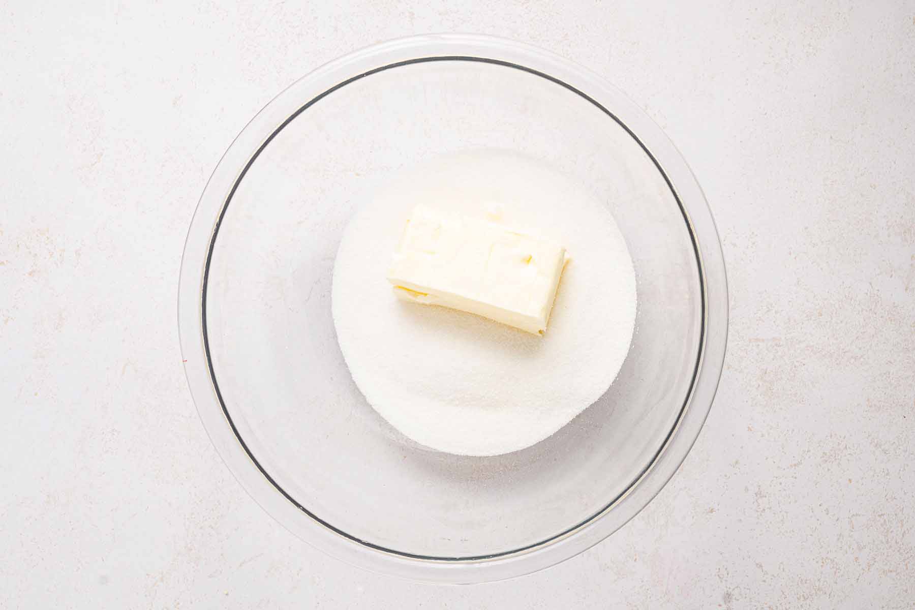 Butter and sugar in a glass bowl, ready to be creamed for the cake batter