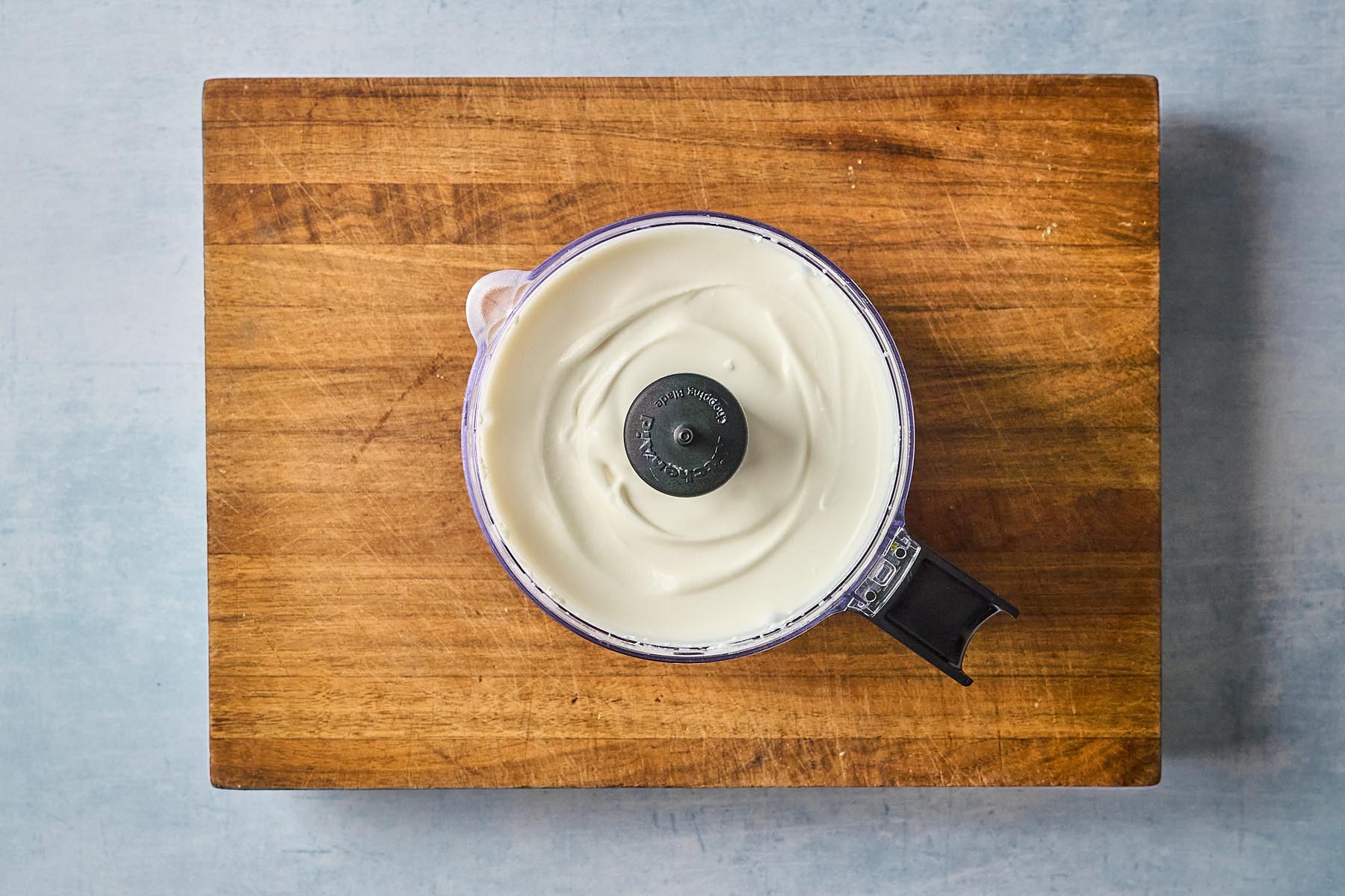 Smooth whipped cottage cheese in a food processor after blending, creamy and ready for serving.