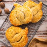 Pumpkin-shaped hand pies with spiced filling and golden sugar crust — an easy fall baking idea for Thanksgiving dessert.