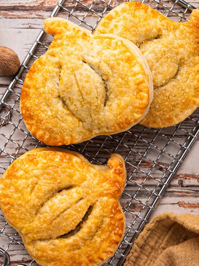 Pumpkin-shaped hand pies with spiced filling and golden sugar crust — an easy fall baking idea for Thanksgiving dessert.