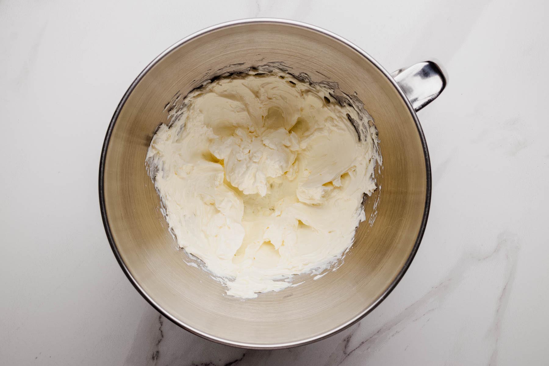 Cream cheese beaten until smooth in a stainless steel mixing bowl.