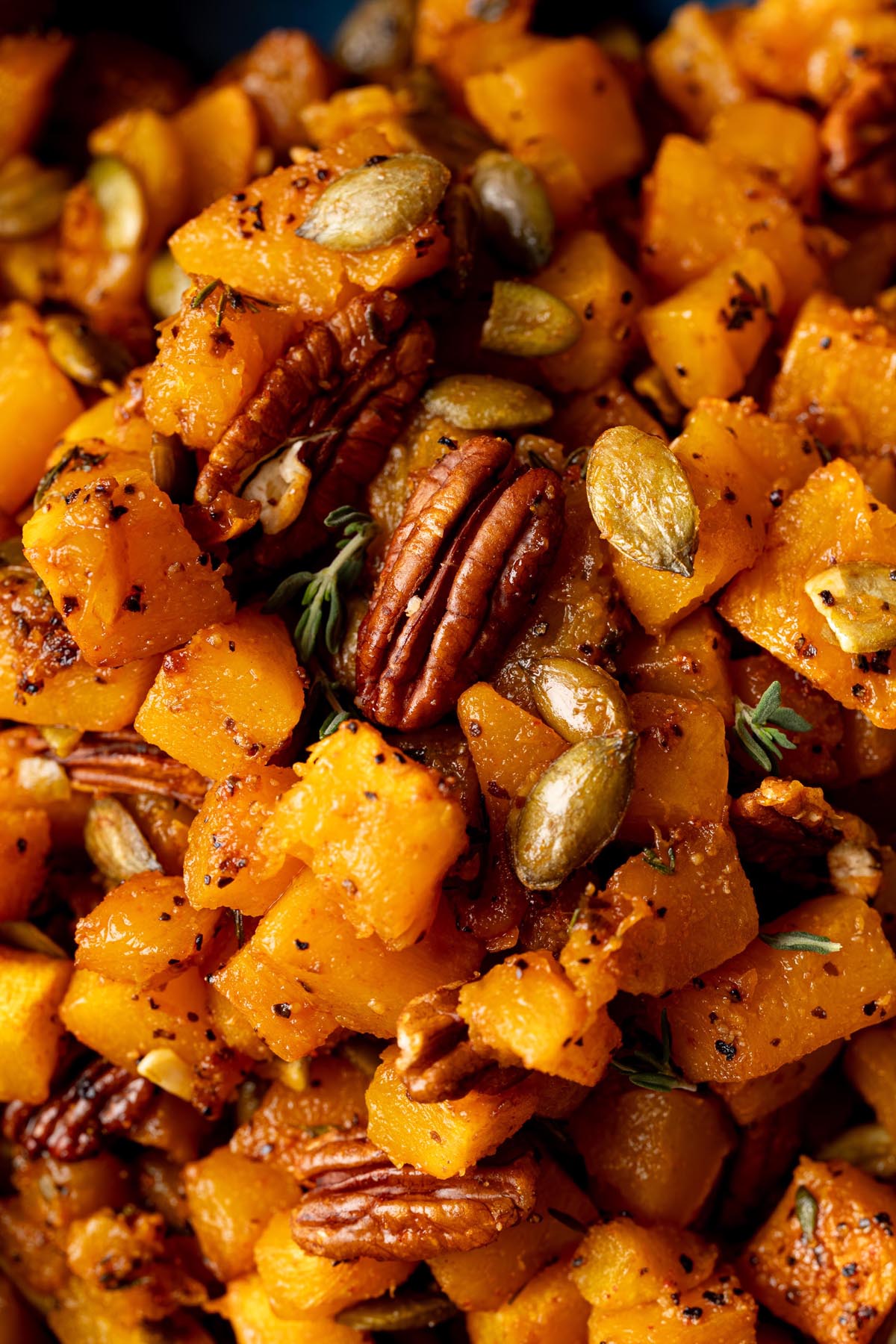 Close-up of caramelized squash with pecans and pumpkin seeds