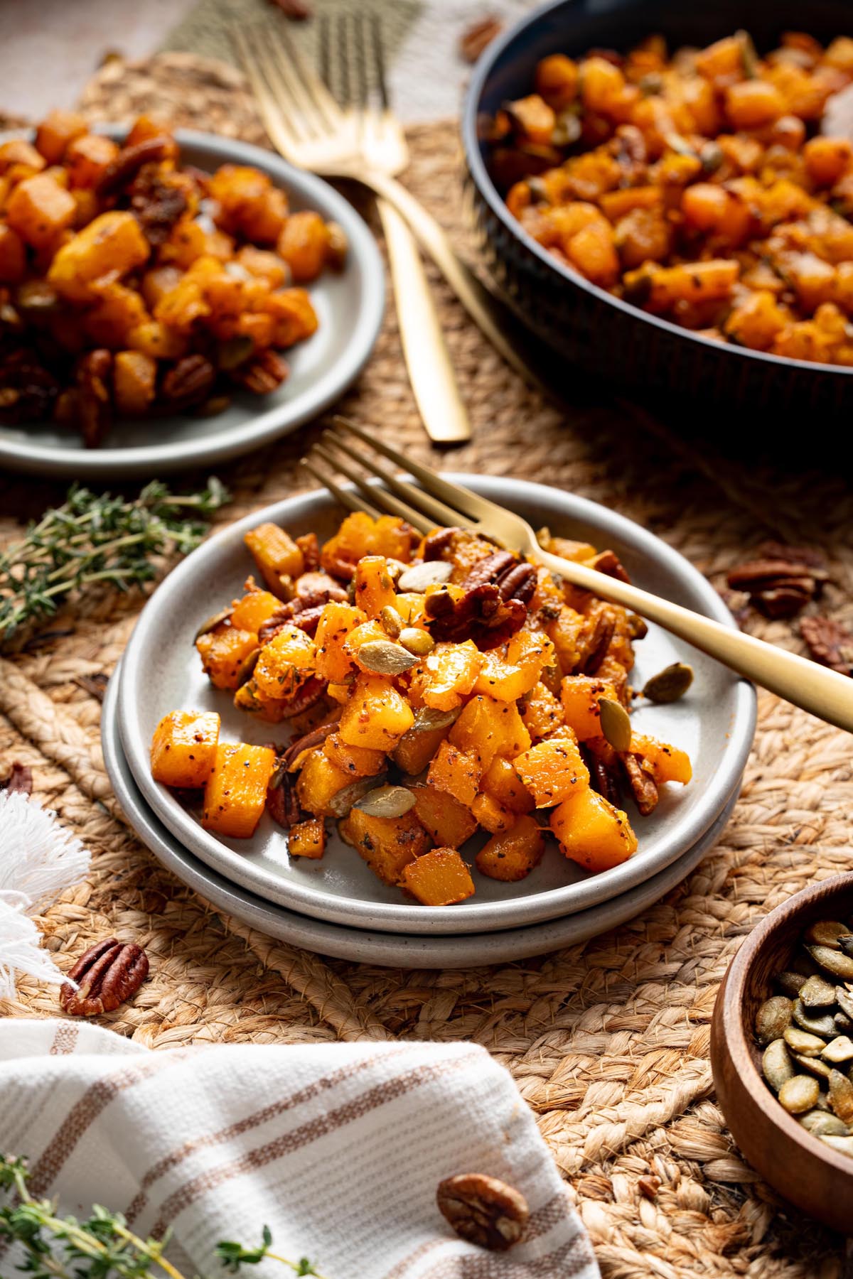 Plated serving of maple roasted butternut squash with pecans and pumpkin seeds