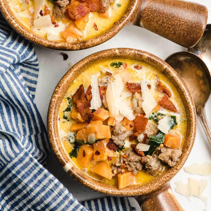 Creamy sausage, kale, and sweet potato soup topped with bacon and Parmesan.