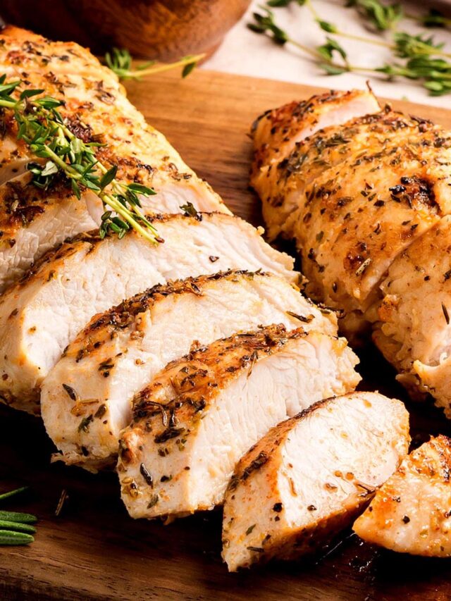 Sliced oven-roasted turkey tenderloins with herb crust, juicy interior.