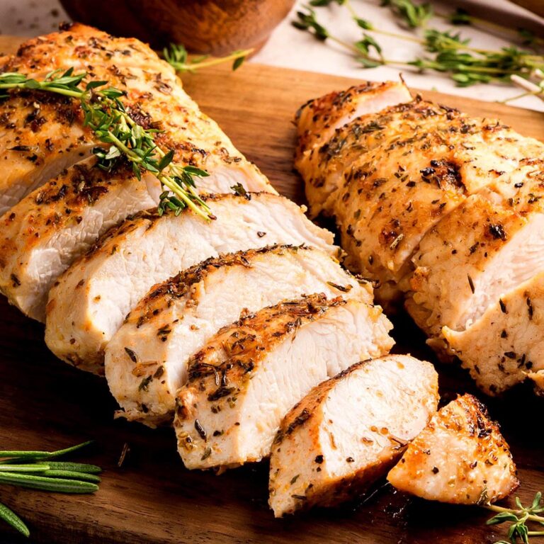 Sliced oven-roasted turkey tenderloins with herb crust, juicy interior.