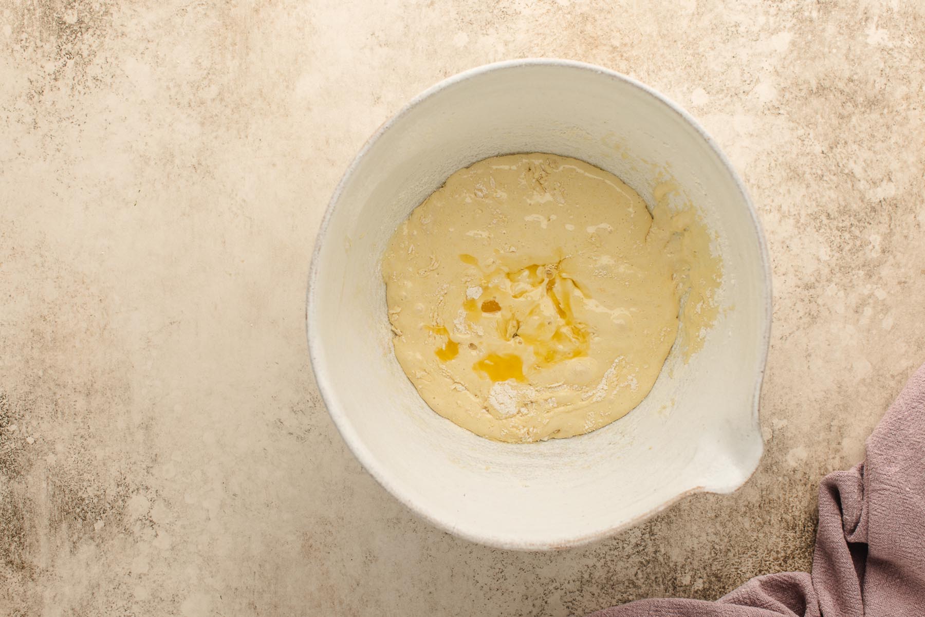 Cooled melted butter just added to the thick batter.