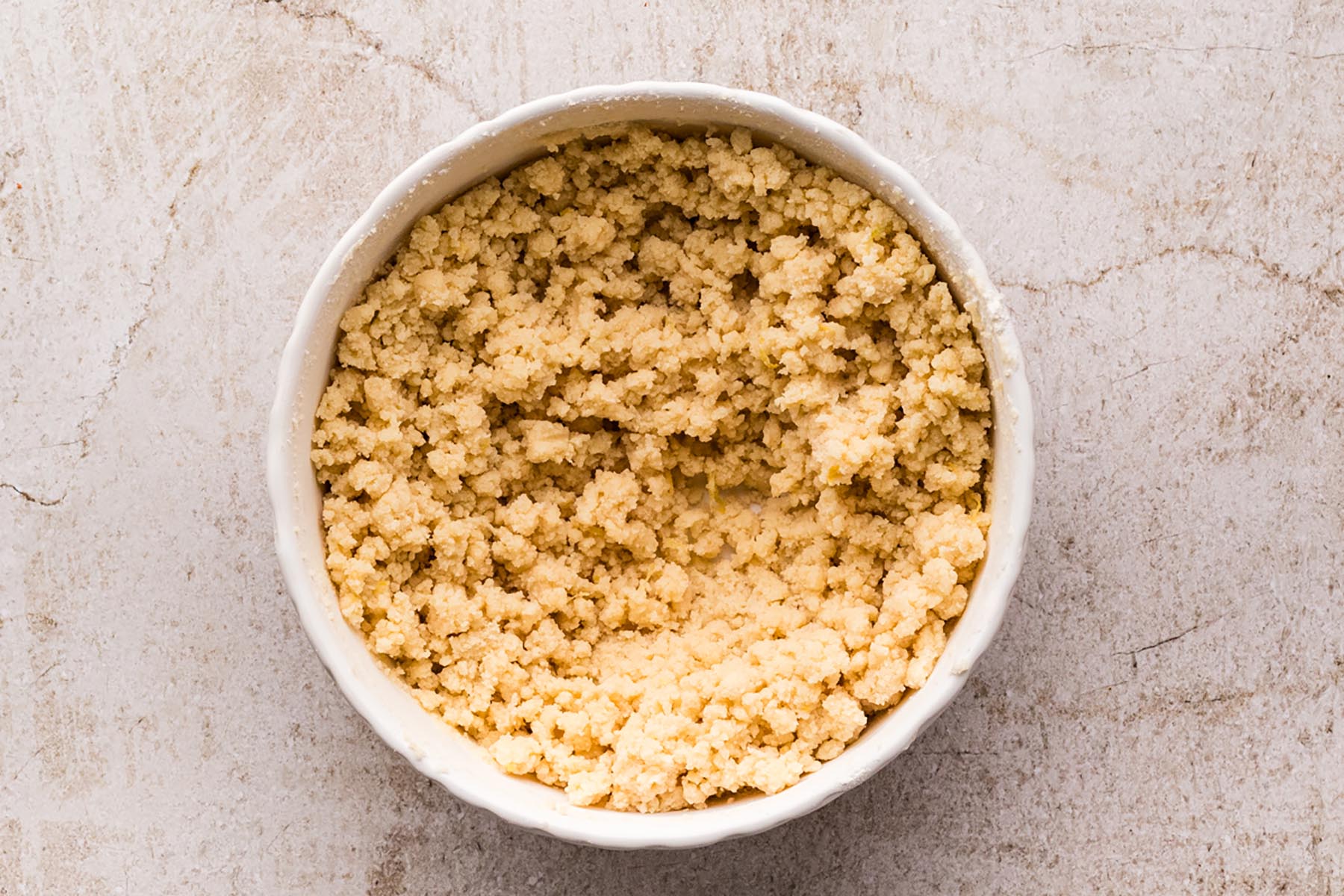 Cookie dough with a crumbly texture after the flour has been mixed into the butter and sugar.