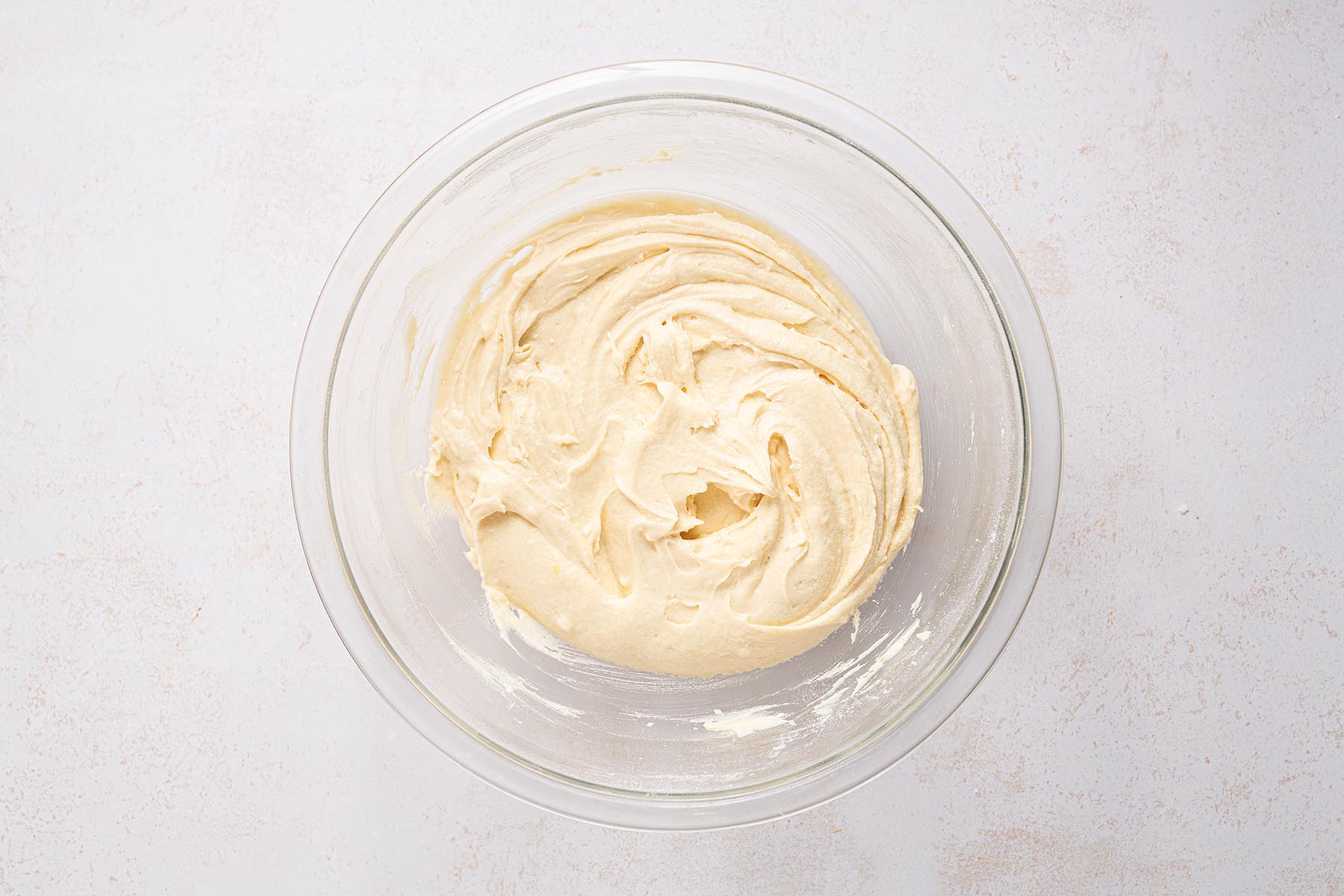 Thick vanilla cake batter mixed until smooth.