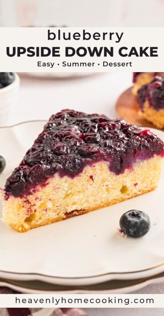 Close-up slice of blueberry upside down cake with a thick glossy blueberry topping and tender yellow cake, served on a white plate with fresh blueberries and text overlay reading “Blueberry Upside Down Cake.”