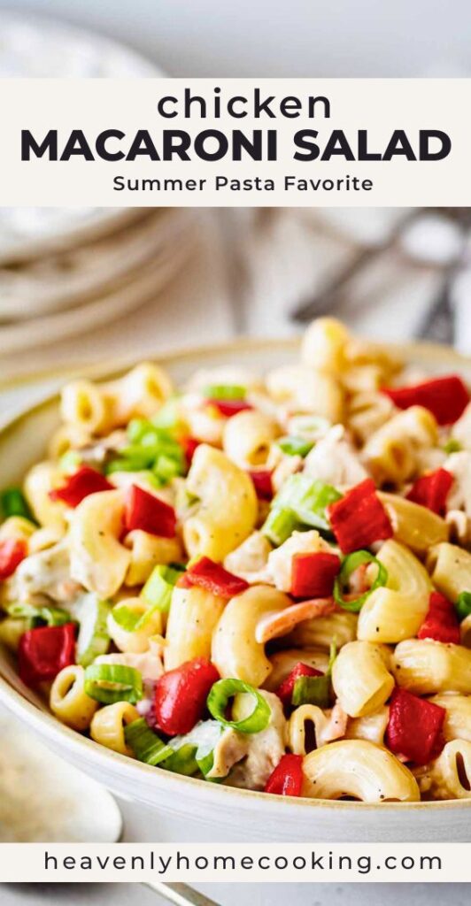 Creamy chicken macaroni salad with elbow pasta, diced red peppers, green onions, and chunks of chicken in a large serving bowl. Vertical Pinterest pin for a chicken macaroni salad summer pasta recipe from Heavenly Home Cooking.