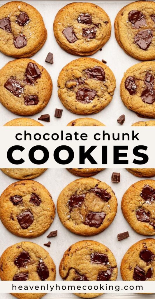 Chocolate chunk cookies baked until golden brown with large melted chocolate chunks and flaky sea salt on a baking sheet. Vertical Pinterest pin for homemade bakery-style chocolate chunk cookies from Heavenly Home Cooking.
