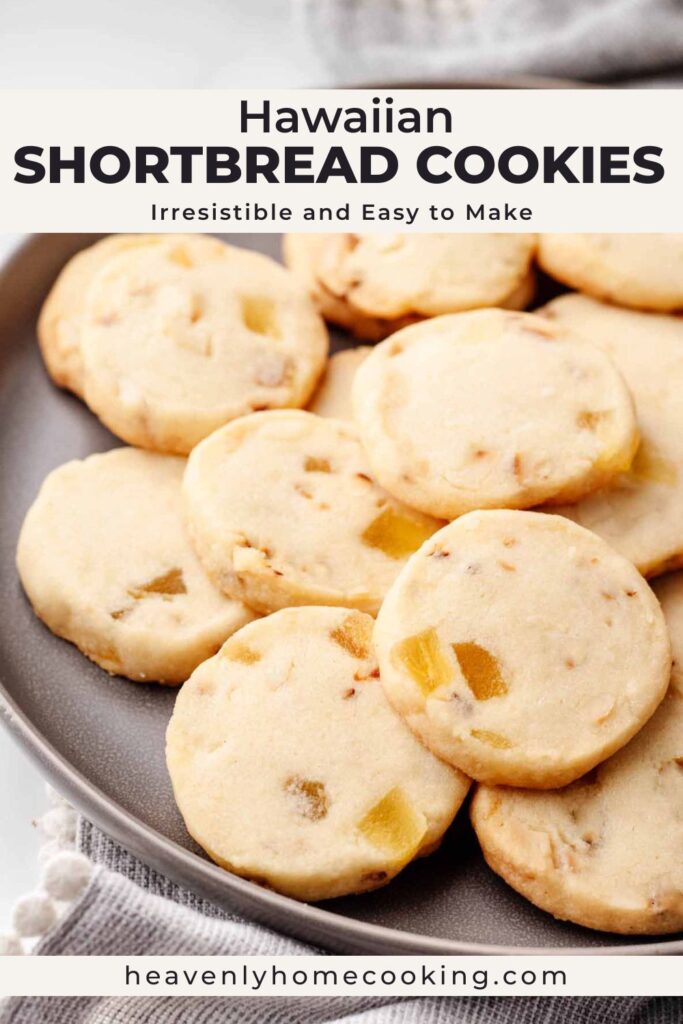 Plate of Hawaiian shortbread cookies filled with pineapple pieces. Vertical Pinterest pin for easy homemade Hawaiian shortbread cookies from Heavenly Home Cooking.