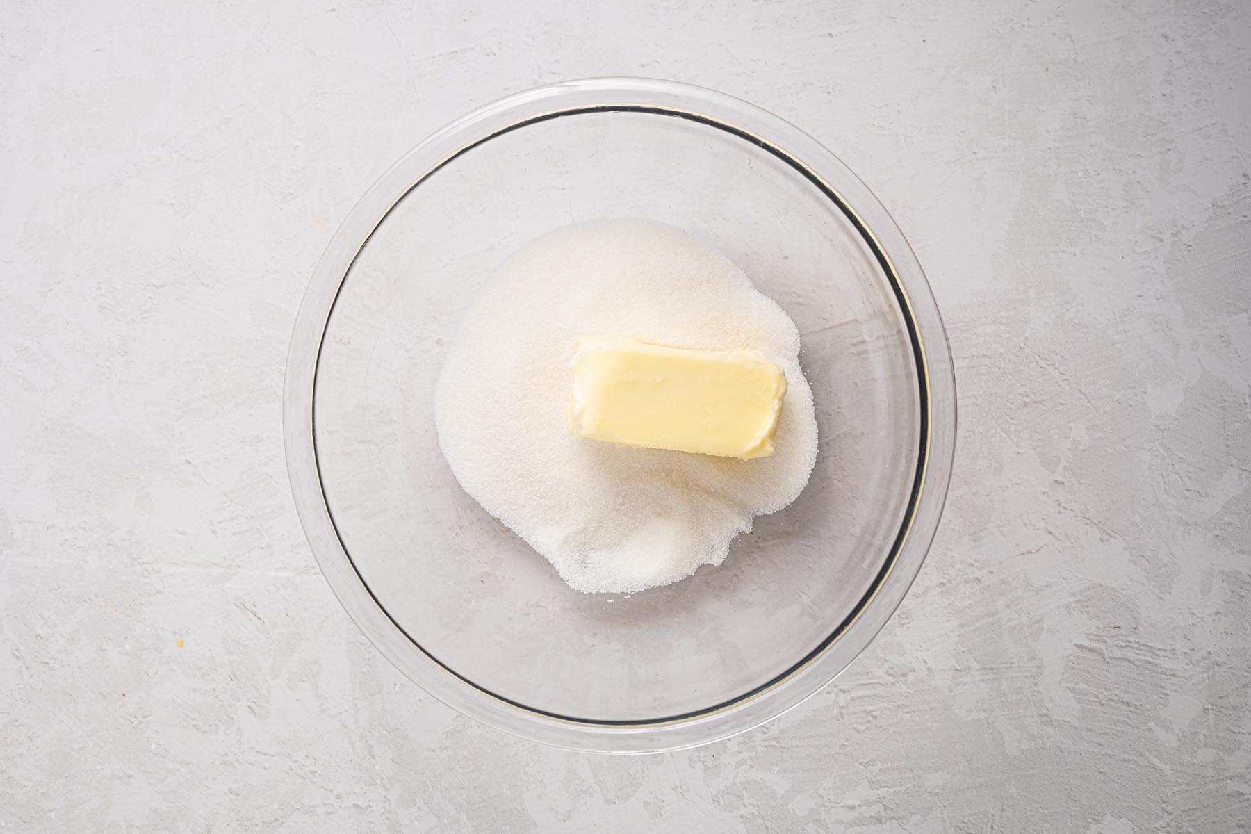 Butter and granulated sugar in a mixing bowl before creaming.