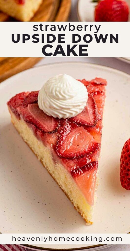 Slice of strawberry upside down cake topped with whipped cream on a plate, featuring fresh baked strawberries and buttery cake. Vertical Pinterest pin for a homemade strawberry dessert recipe from Heavenly Home Cooking.
