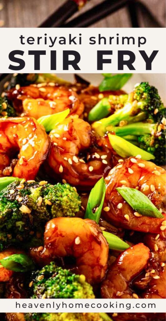 Close-up teriyaki shrimp stir fry with glossy shrimp, broccoli, sesame seeds, and green onions in a savory teriyaki sauce. Vertical Pinterest pin for a teriyaki shrimp stir fry recipe from Heavenly Home Cooking.