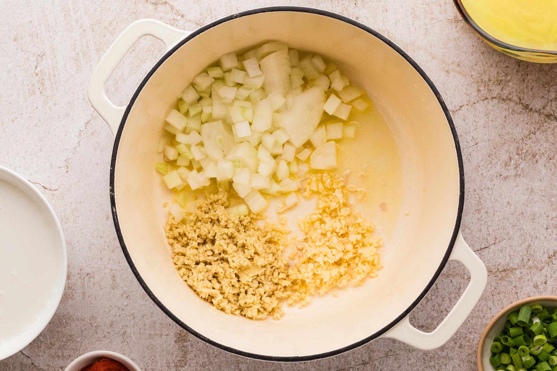 Onion, garlic, and ginger saut&eacute;ing in pot for Thai curry soup.