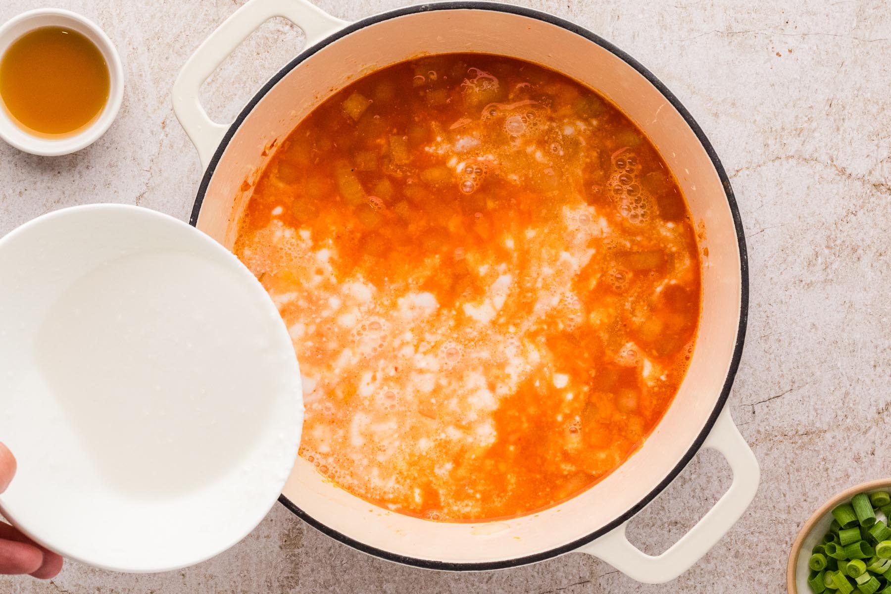 Coconut milk added to create creamy Thai chicken soup broth.