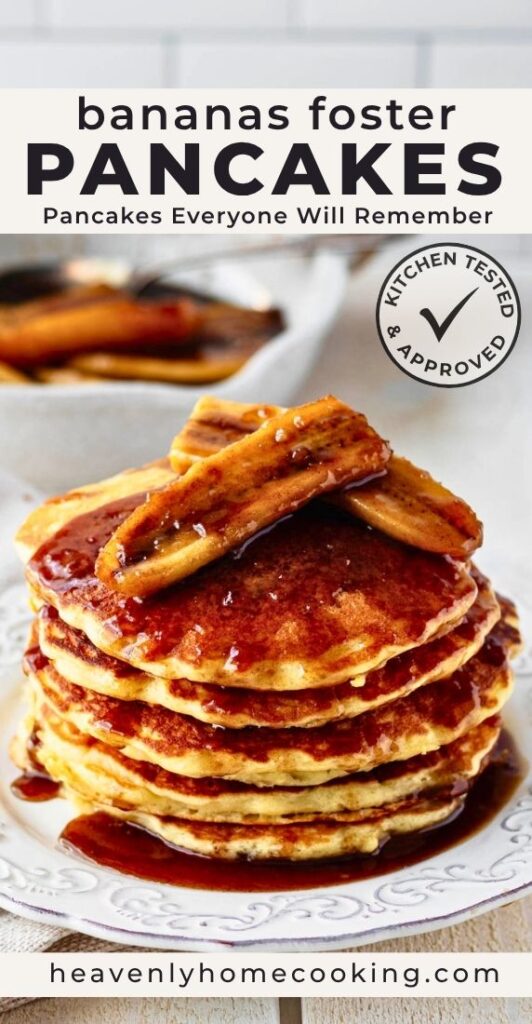 A stack of fluffy Bananas Foster pancakes topped with caramelized bananas and a rich buttery brown sugar sauce on a white plate. This vertical Pinterest pin features a homemade Bananas Foster pancakes recipe from Heavenly Home Cooking.