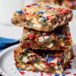 Stack of chewy fireworks blondies made with browned butter, white chocolate chunks, and red, white, and blue sprinkles.
