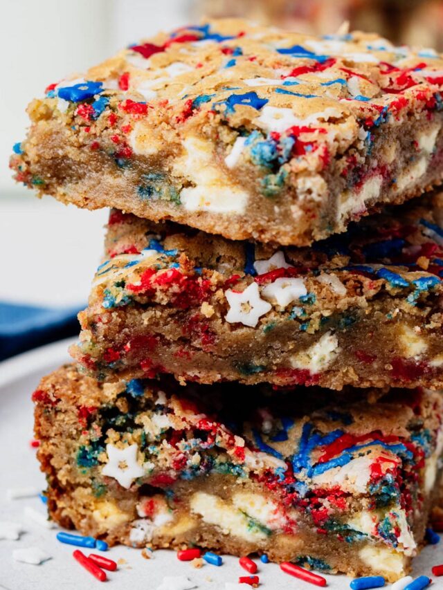 Stack of chewy fireworks blondies made with browned butter, white chocolate chunks, and red, white, and blue sprinkles.
