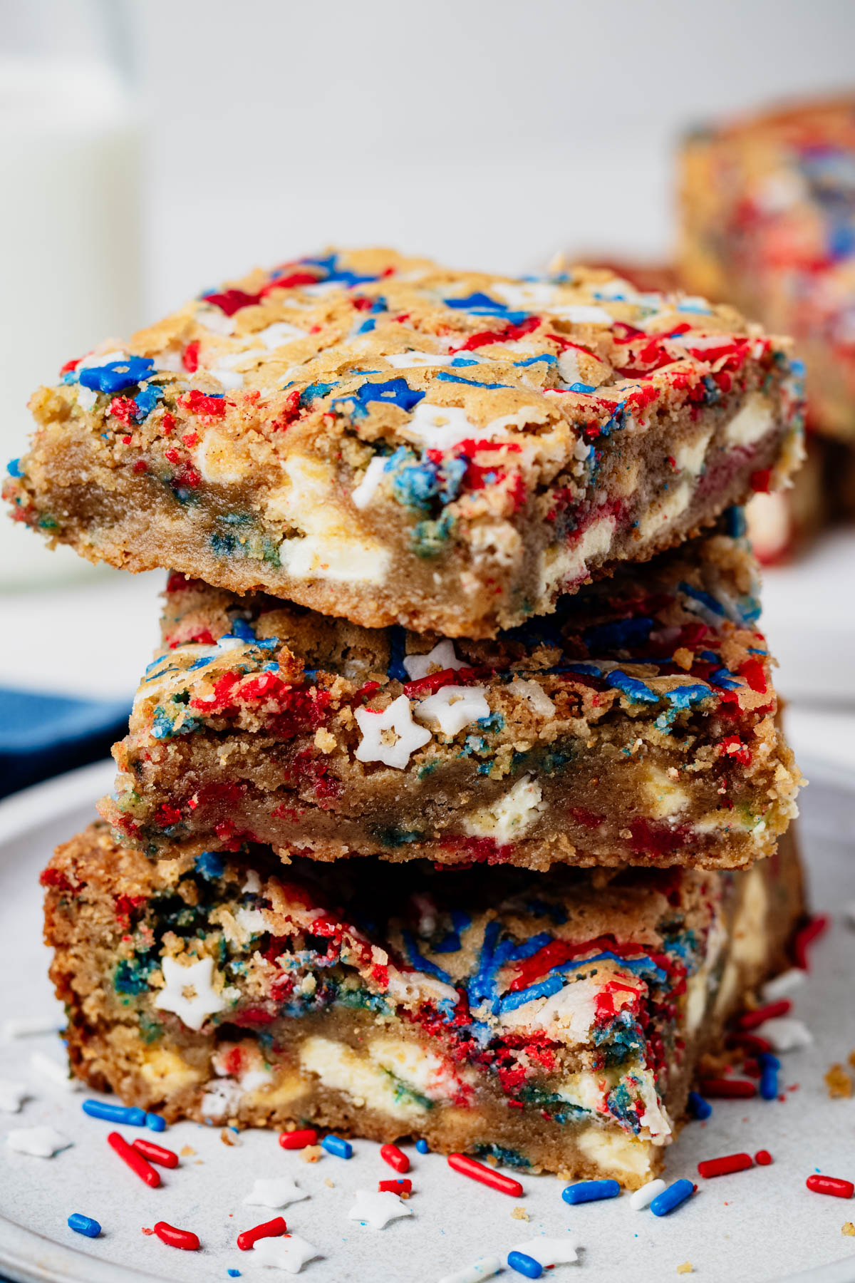 Stacked fireworks blondies with white chocolate chunks, patriotic sprinkles, and a chewy, fudgy interior.