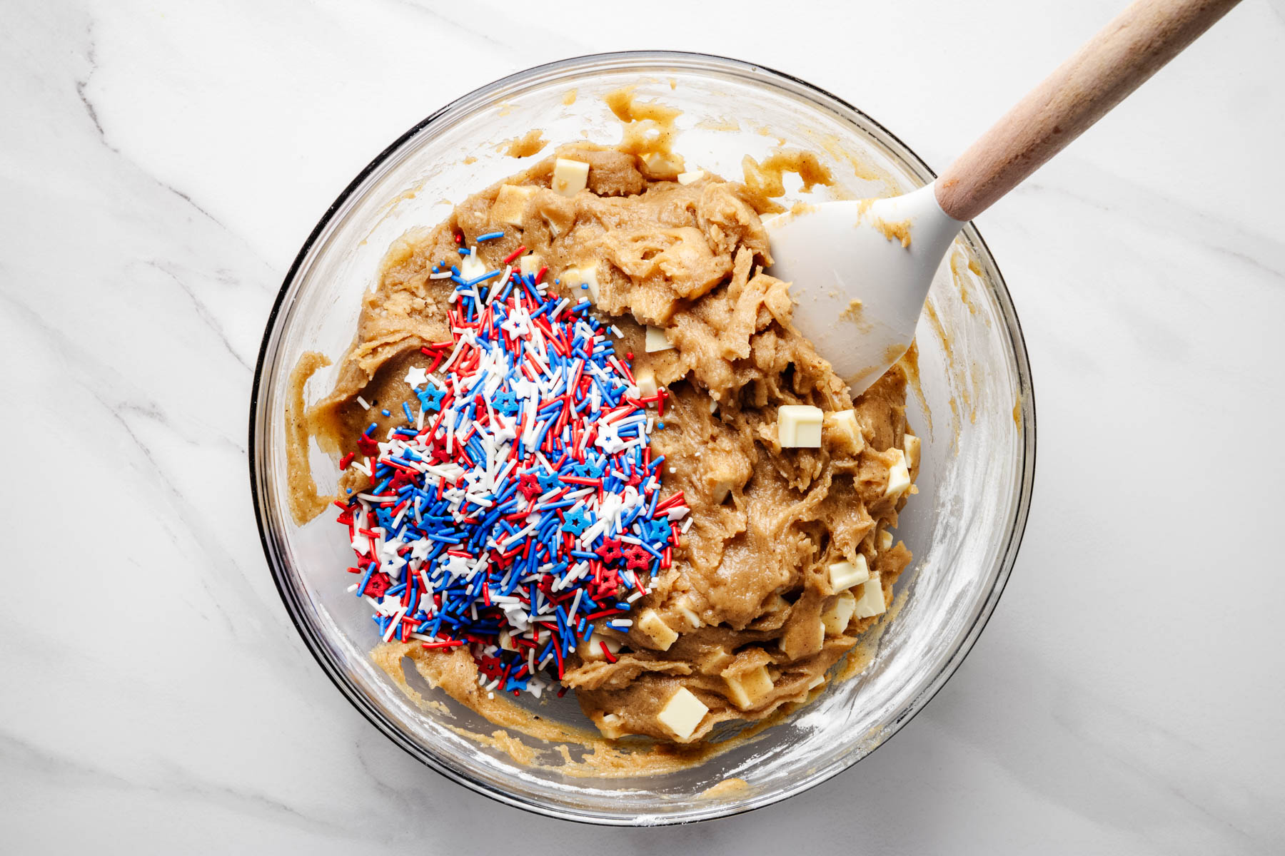 Red, white, and blue sprinkles added to the blondie batter with white chocolate.