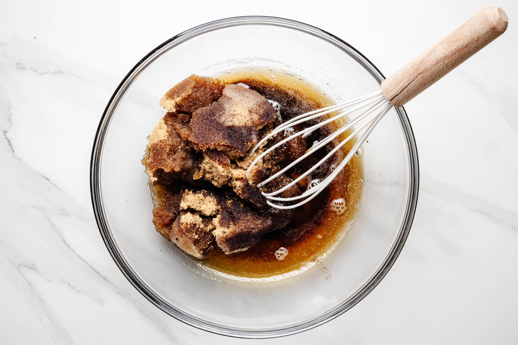 Brown sugar and granulated sugar added to browned butter in a mixing bowl.