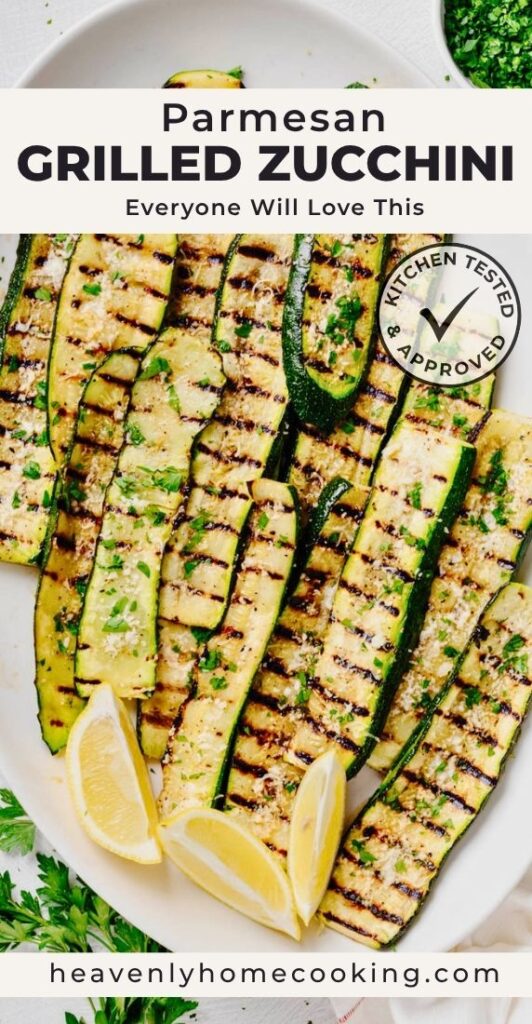 Grilled zucchini topped with grated Parmesan, fresh parsley, and lemon wedges. Vertical Pinterest pin for a homemade Parmesan Grilled Zucchini recipe from Heavenly Home Cooking.