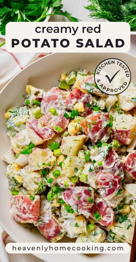 Creamy red potato salad made with red potatoes, hard-boiled eggs, celery, green onions, and fresh dill in a creamy dressing, served in a large bowl. Vertical Pinterest pin for a homemade red potato salad recipe from Heavenly Home Cooking.