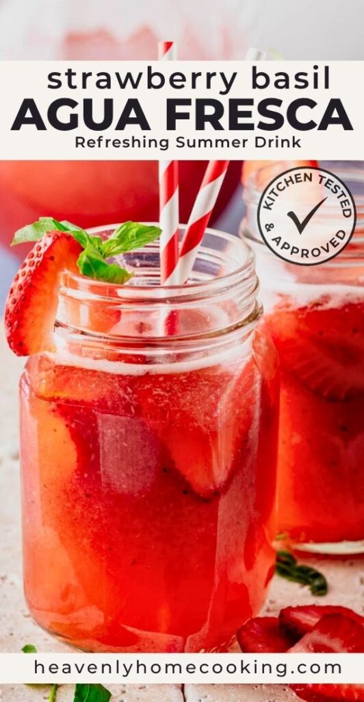 Strawberry basil agua fresca served over ice in mason jars and garnished with fresh strawberry slices and basil leaves. Bright red fruit drink with striped paper straws, shown in a close-up summer beverage scene. Vertical Pinterest pin for a refreshing strawberry basil agua fresca recipe from Heavenly Home Cooking.