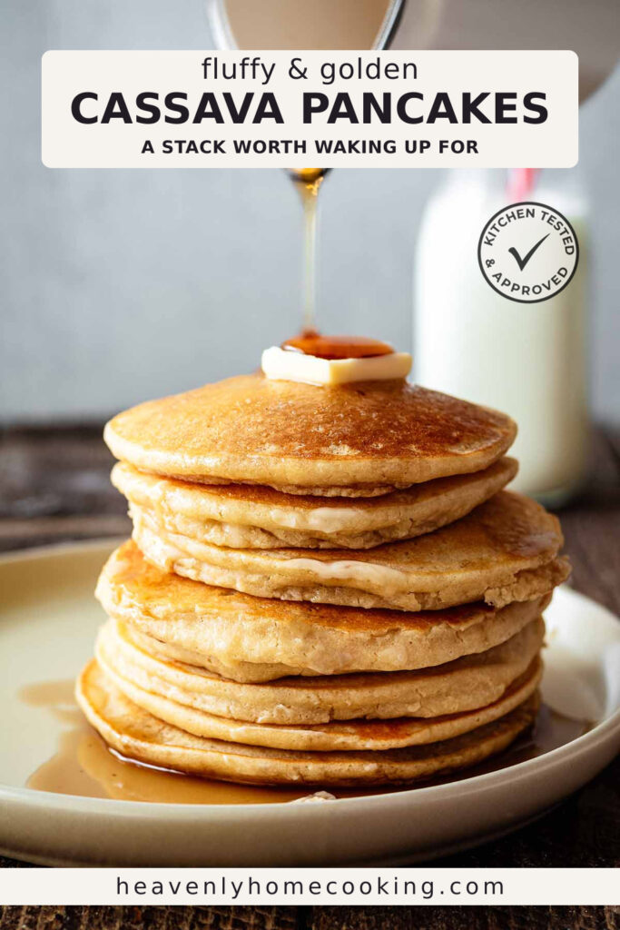 A stack of fluffy, golden cassava pancakes is topped with a pat of butter as warm maple syrup is poured over the top. A glass bottle of milk sits in the background, and the Pinterest pin includes the text "Fluffy & Golden Cassava Pancakes – A Stack Worth Waking Up For." This vertical Pinterest pin features a homemade cassava pancakes recipe from Heavenly Home Cooking.