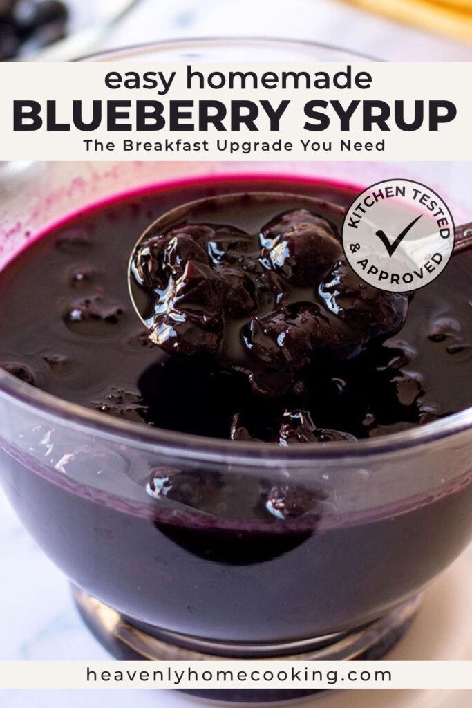 A close-up of homemade blueberry syrup with whole blueberries in a glass bowl and a spoon lifting the thick, glossy syrup. This vertical Pinterest pin features a homemade blueberry syrup recipe from Heavenly Home Cooking.