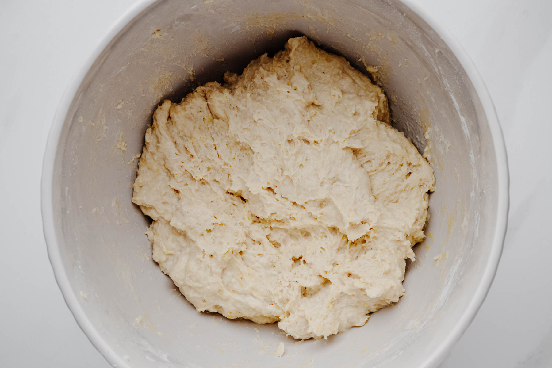 Shaggy garlic dinner roll dough after the ingredients have been mixed together but before kneading.