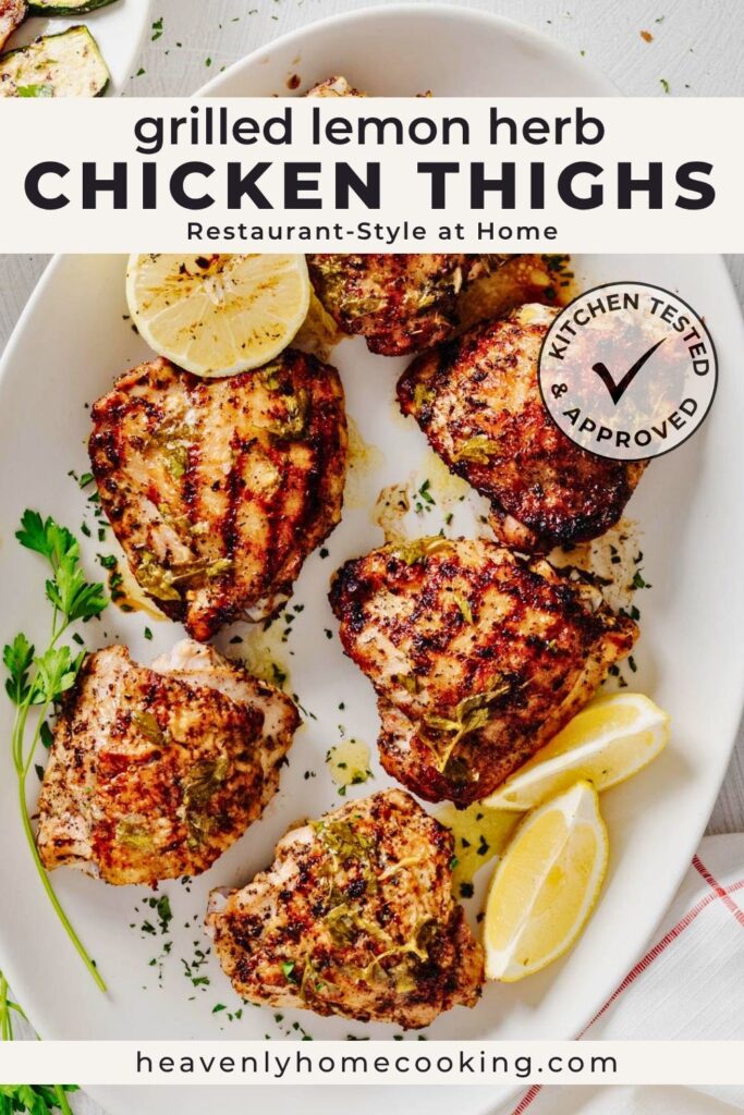 A platter of grilled lemon herb chicken thighs with golden, charred grill marks, grilled lemon halves, fresh parsley, and lemon wedges, served on a white platter. This vertical Pinterest pin features a homemade grilled lemon herb chicken thighs recipe from Heavenly Home Cooking.
