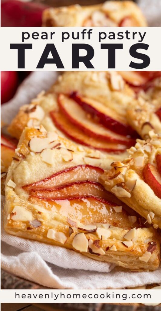 Golden pear puff pastry tarts are topped with thinly sliced red pears, almond cream, and sliced almonds on flaky, buttery pastry. This vertical Pinterest pin features a homemade pear puff pastry tarts recipe from Heavenly Home Cooking.