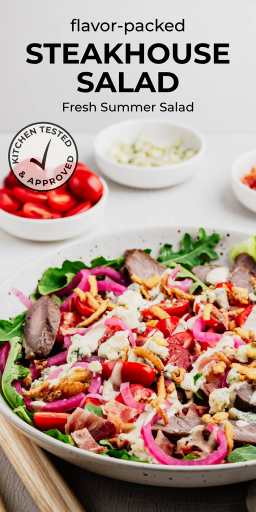 A vertical Pinterest pin featuring a loaded steakhouse salad made with sliced steak, crisp greens, cherry tomatoes, blue cheese, quick pickled red onions, crispy fried onions, bacon, and creamy dressing. The pin is titled "Flavor-Packed Steakhouse Salad" with the subtitle "Fresh Summer Salad" and includes the Heavenly Home Cooking Kitchen Tested & Approved badge.