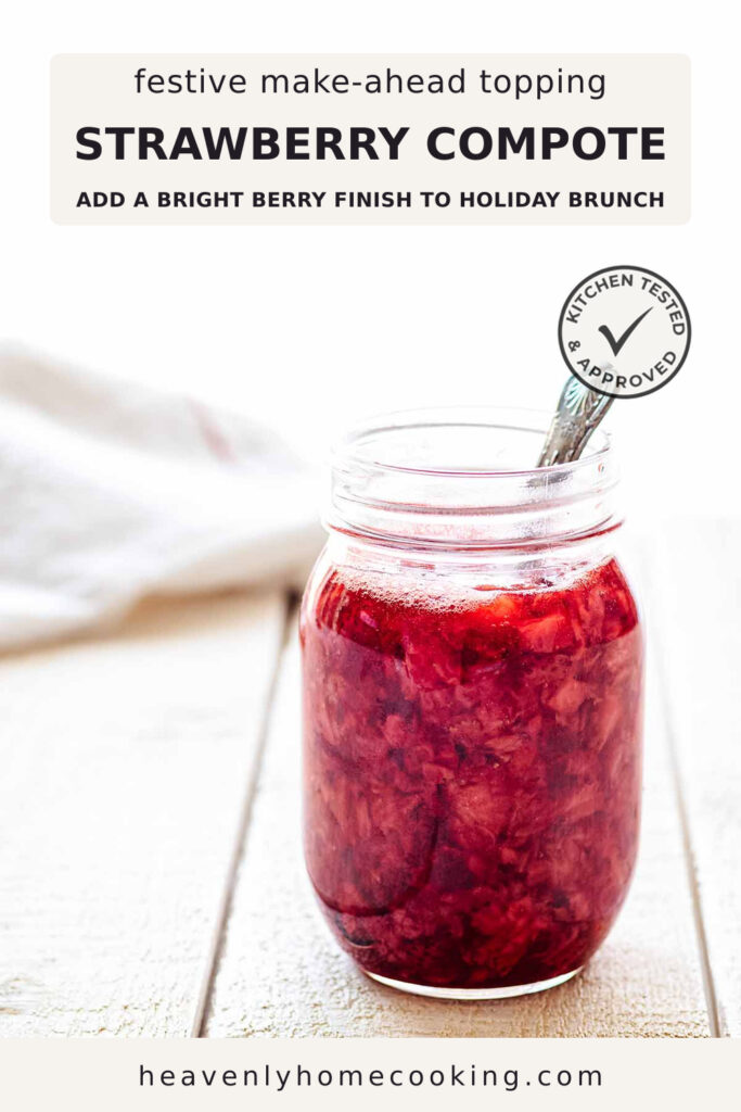 A glass jar filled with chunky homemade strawberry compote sits on a light wood surface with a spoon tucked inside. The Pinterest pin includes the text "Festive Make-Ahead Topping Strawberry Compote – Add a Bright Berry Finish to Holiday Brunch." This vertical Pinterest pin features a homemade strawberry compote recipe from Heavenly Home Cooking.